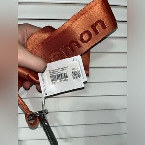 Lululemon never lost keychain in burnt apricot and Tara orange